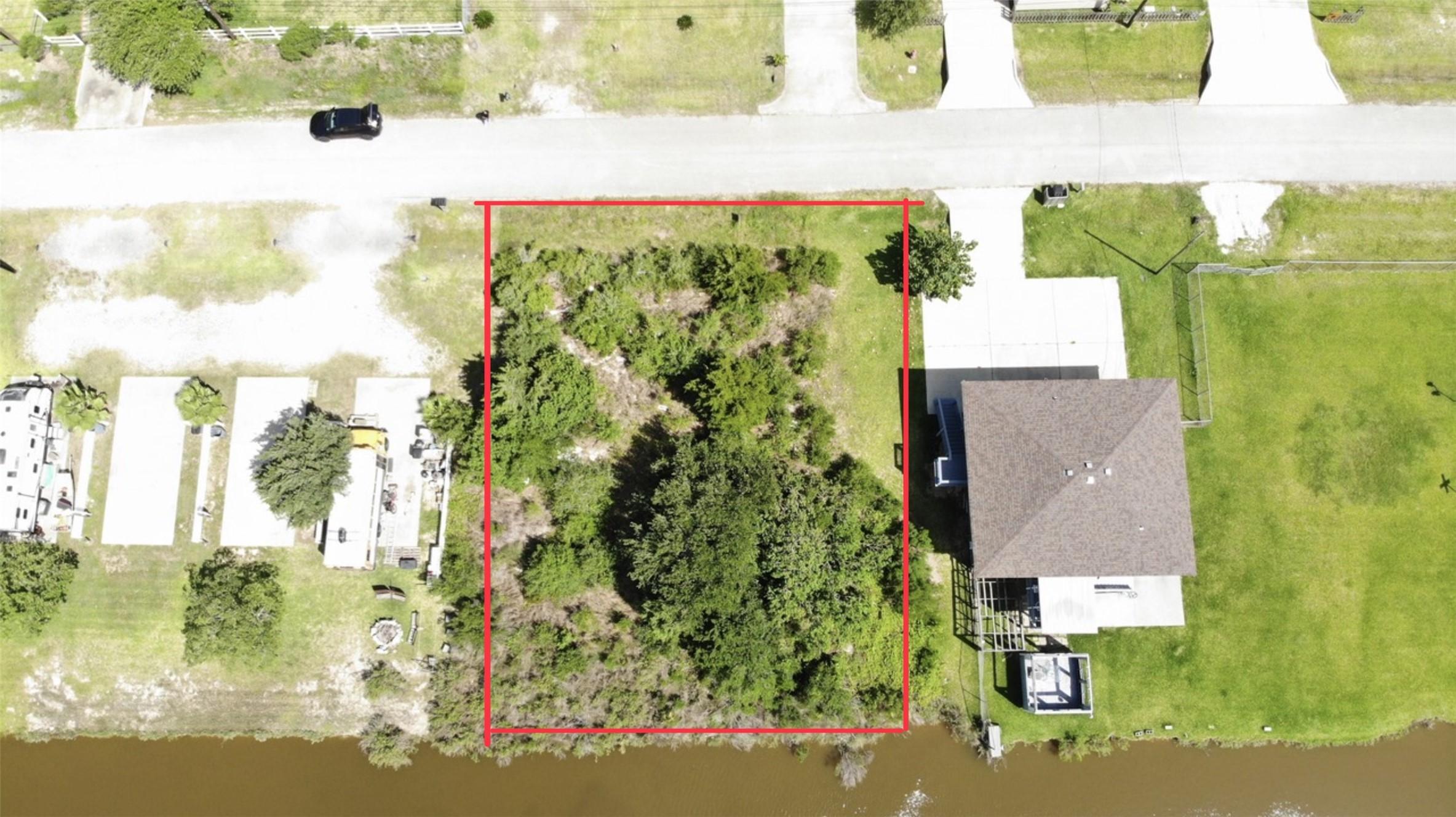 Image 2: Aerial view shows a lot outlined in red, offering