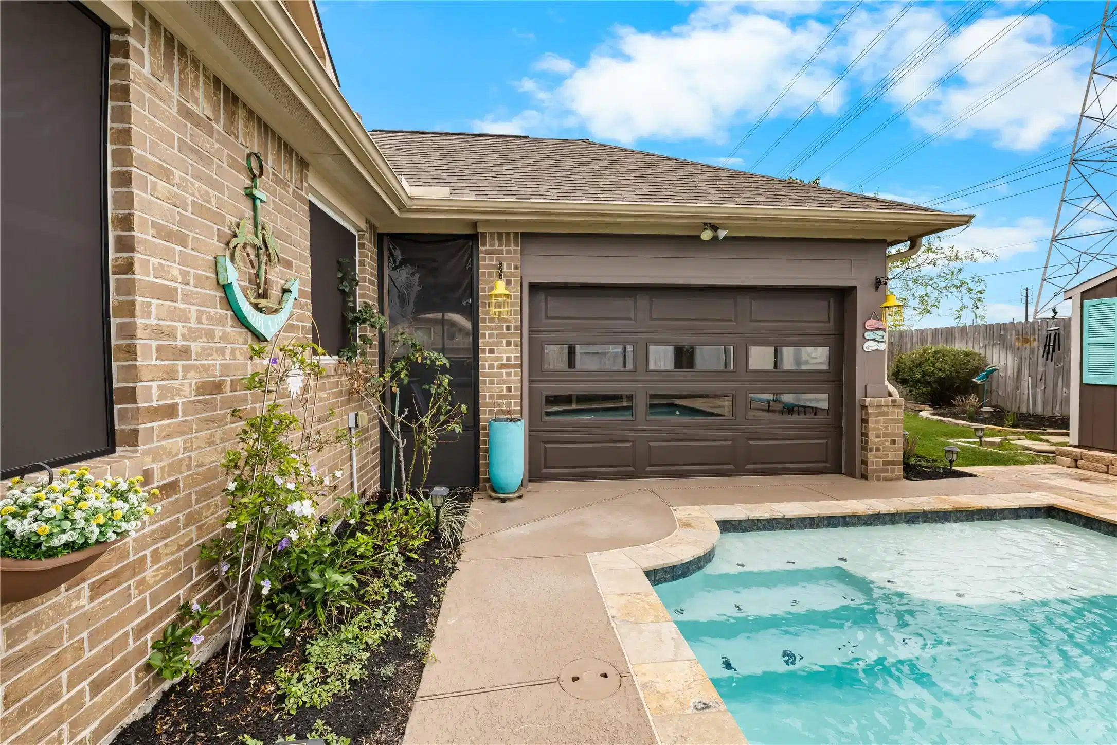 Image 1: Charming backyard featuring a cozy pool adjacent t