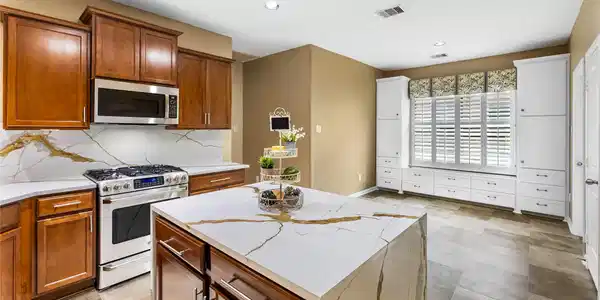 Image 3: Modern kitchen featuring warm wood cabinetry, eleg