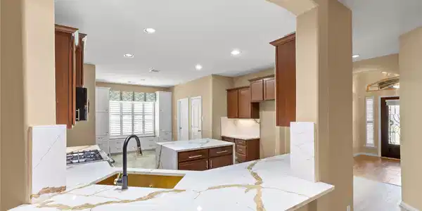 Image 4: This kitchen features elegant marble countertops,