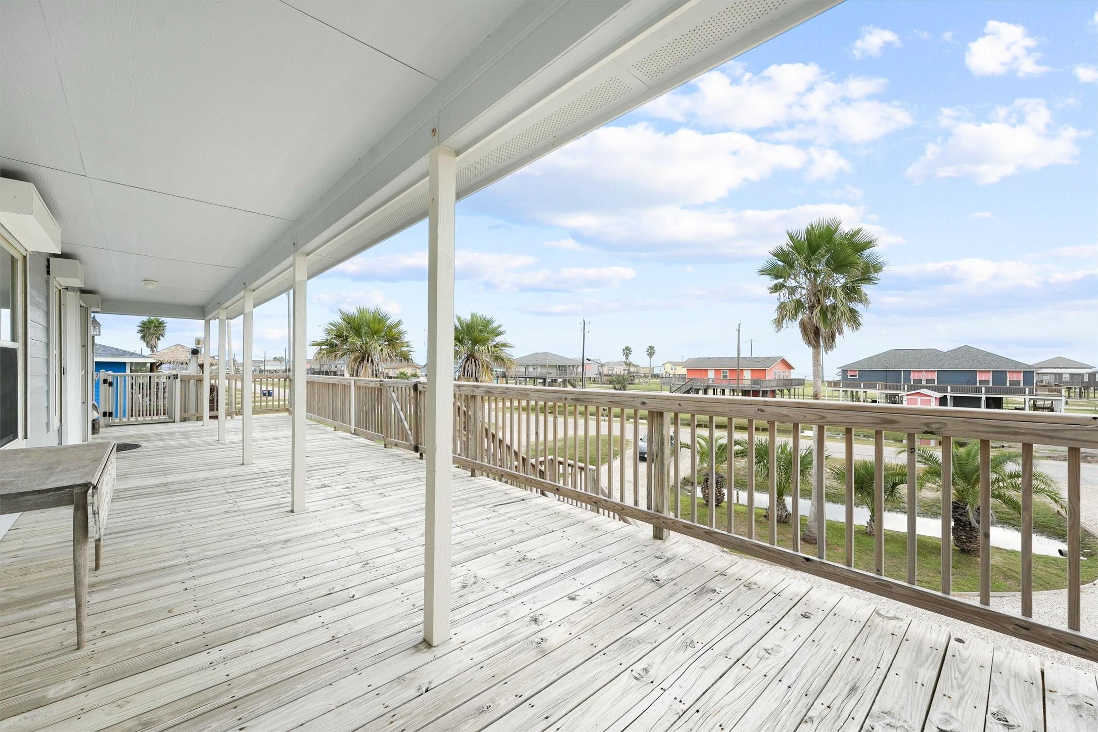 Image 1: Enjoy a spacious front porch with views of the bea