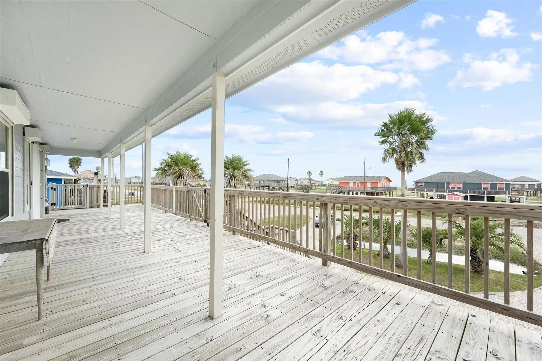 Image 1: Enjoy a spacious front porch with views of the bea