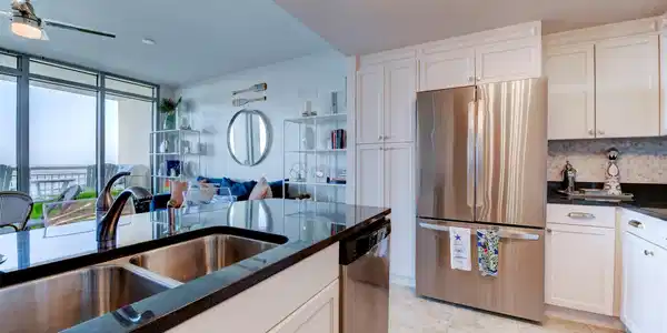 Image 3: Open-concept kitchen keeps the water views in sigh