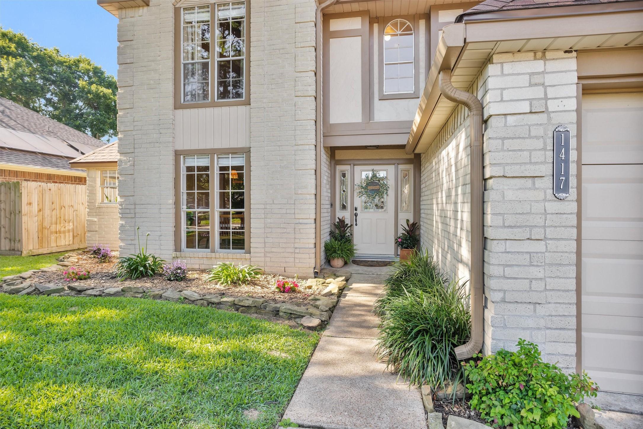 Image 2: Charming two-story home with a welcoming entrance,