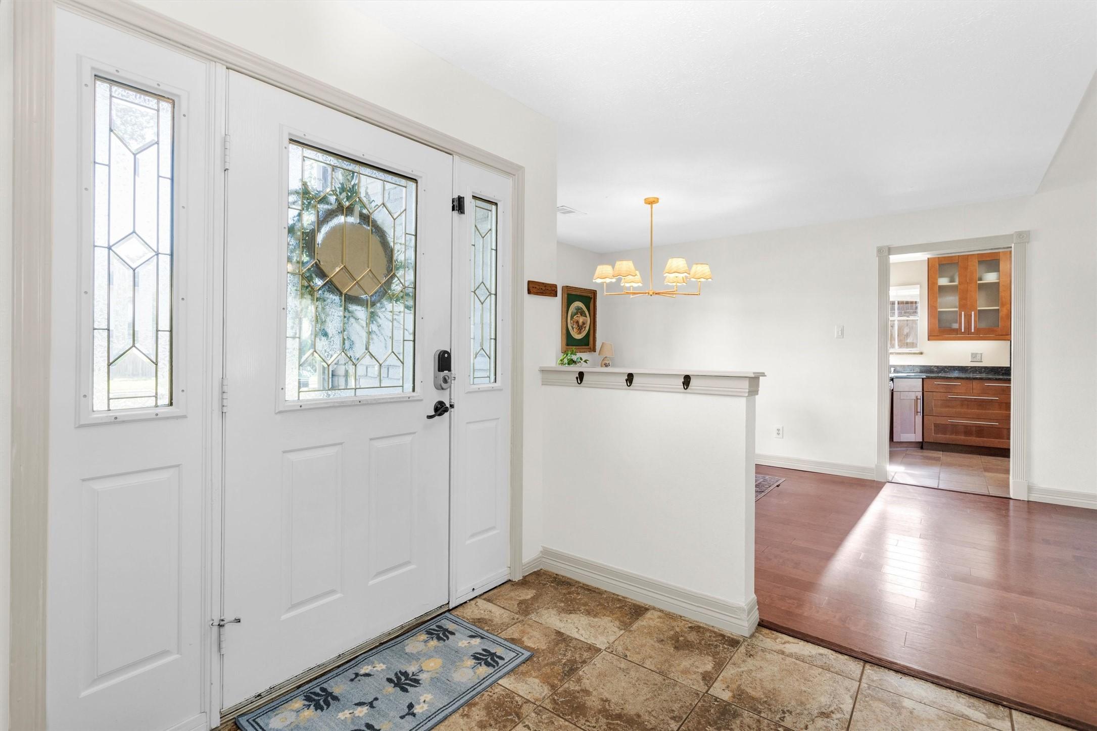 Image 4: Entryway features elegant glass-paneled doors.