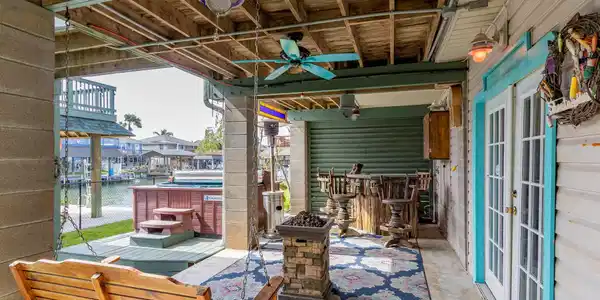 Image 3: Ground level entertainment area with hot tub and b