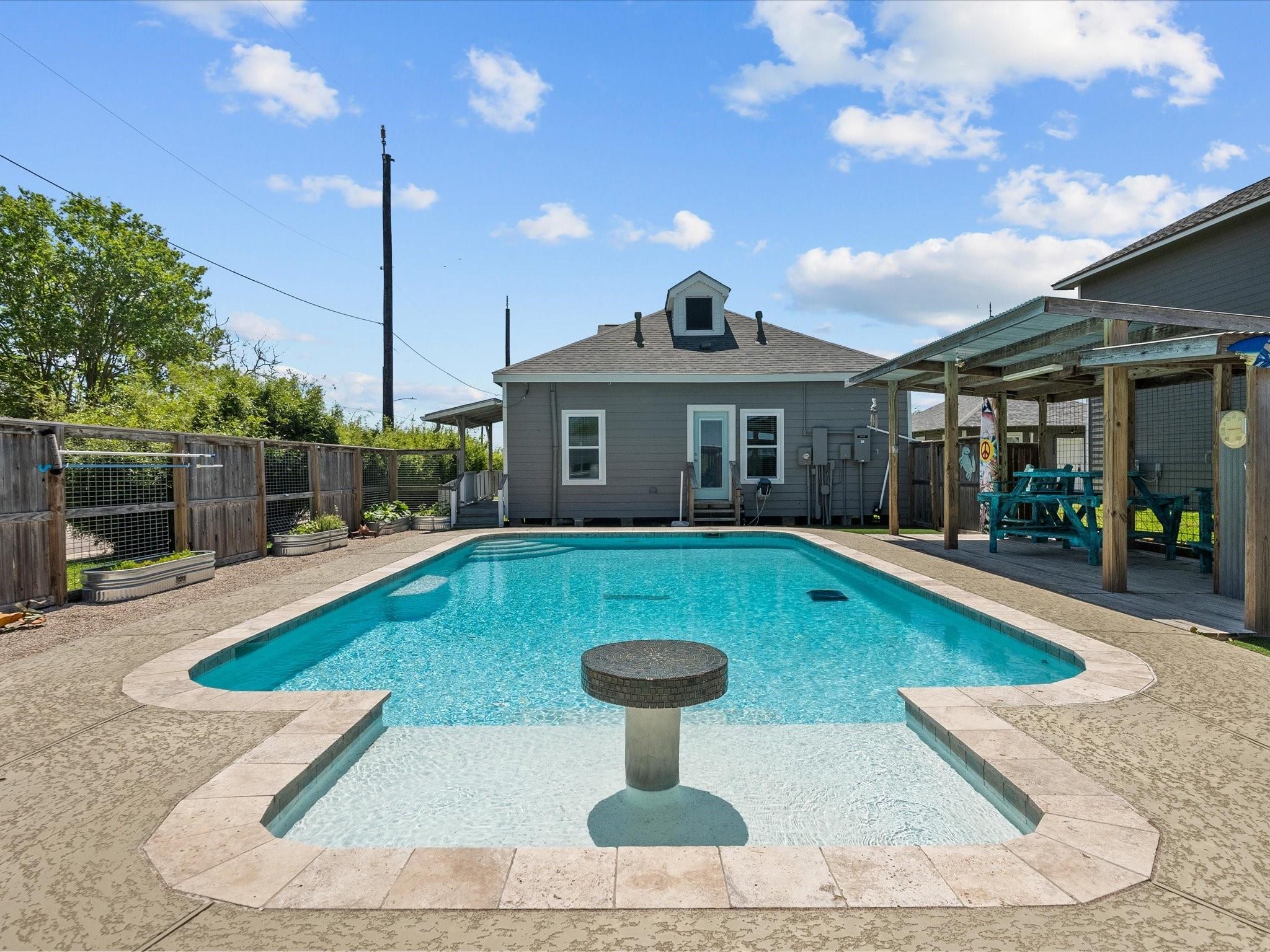 Image 4: This photo features a charming backyard with a spa