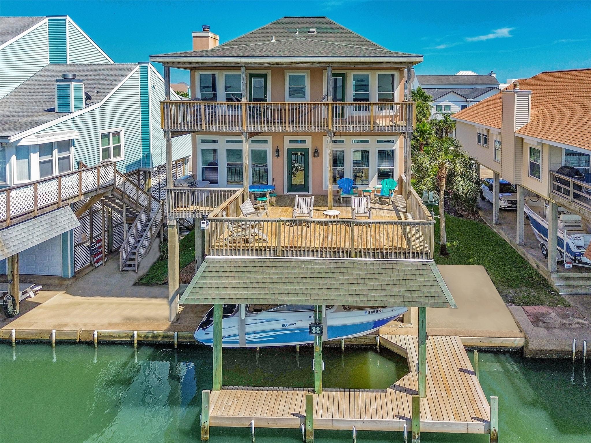 Image 1: Bayfront home features two expansive decks, a cove