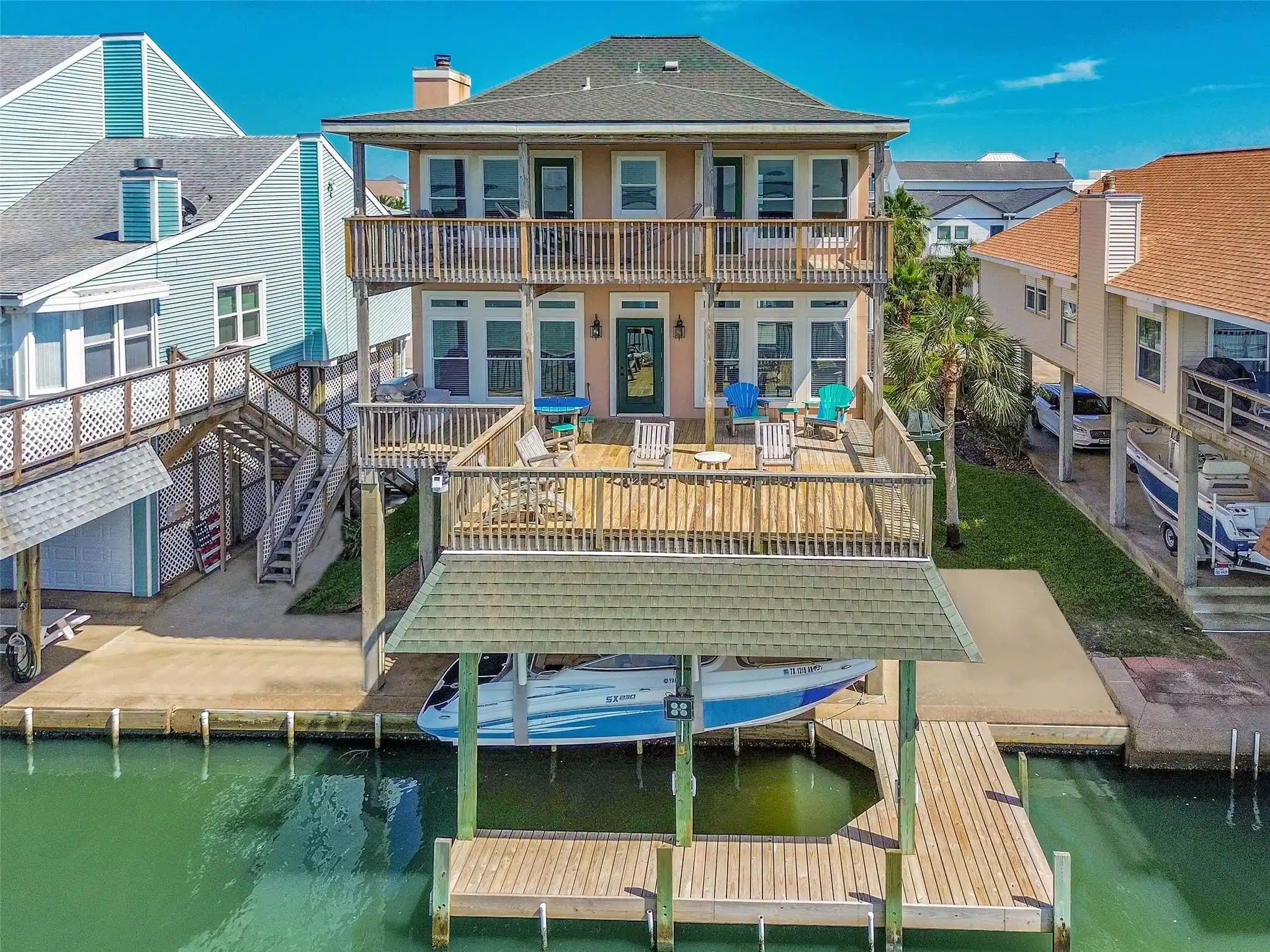 Image 1: Bayfront home features two expansive decks, a cove