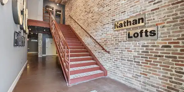 Image 2: The secured entry welcomes you with exposed brick