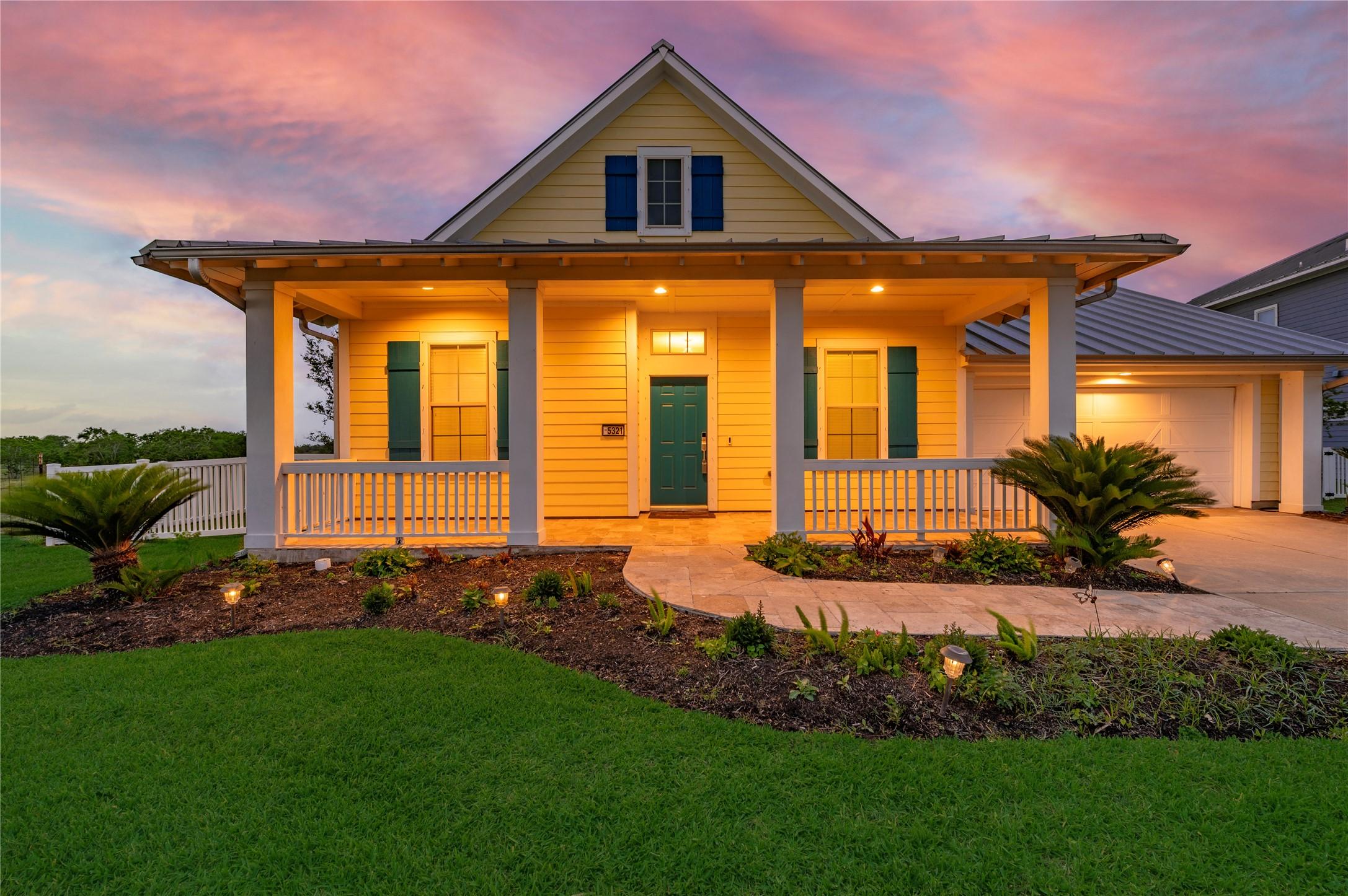 Image 2: David Weekley home features metal roof and Hardy P