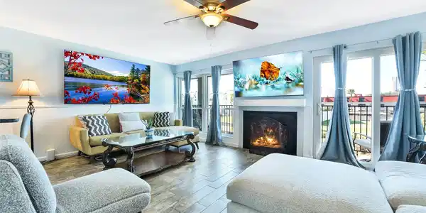 Image 3: Living area with fireplace and natural light conne