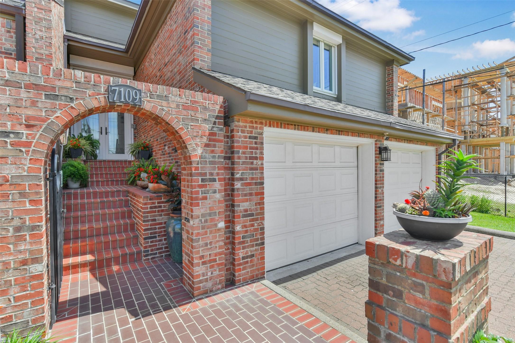 Image 3: Charming brick home with an inviting arched entryw