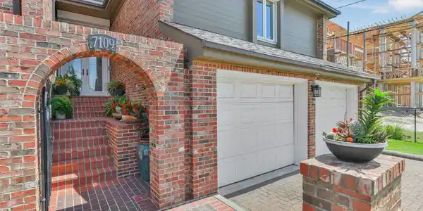Image 3: Charming brick home with an inviting arched entryw