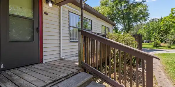 Image 4: This photo shows the entrance of a home with a sma