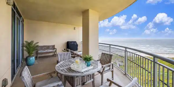 Image 2: Expansive covered balcony with room to dine, relax