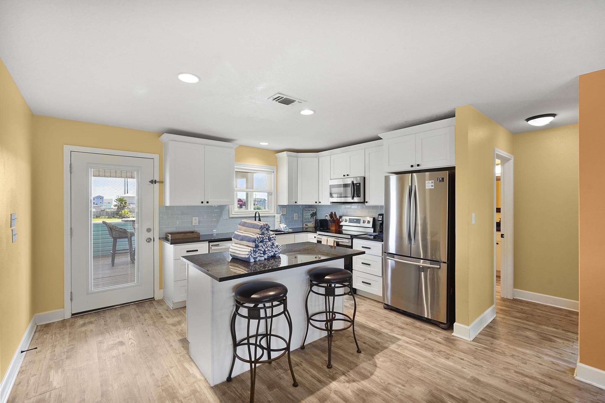 Image 3: Bright and inviting kitchen featuring granite coun