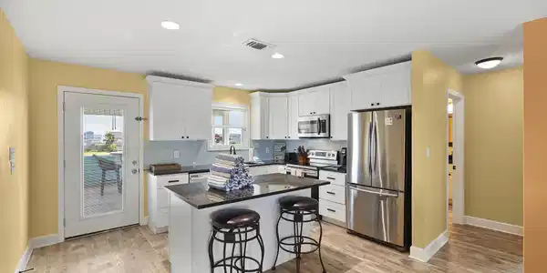 Image 3: Bright and inviting kitchen featuring granite coun
