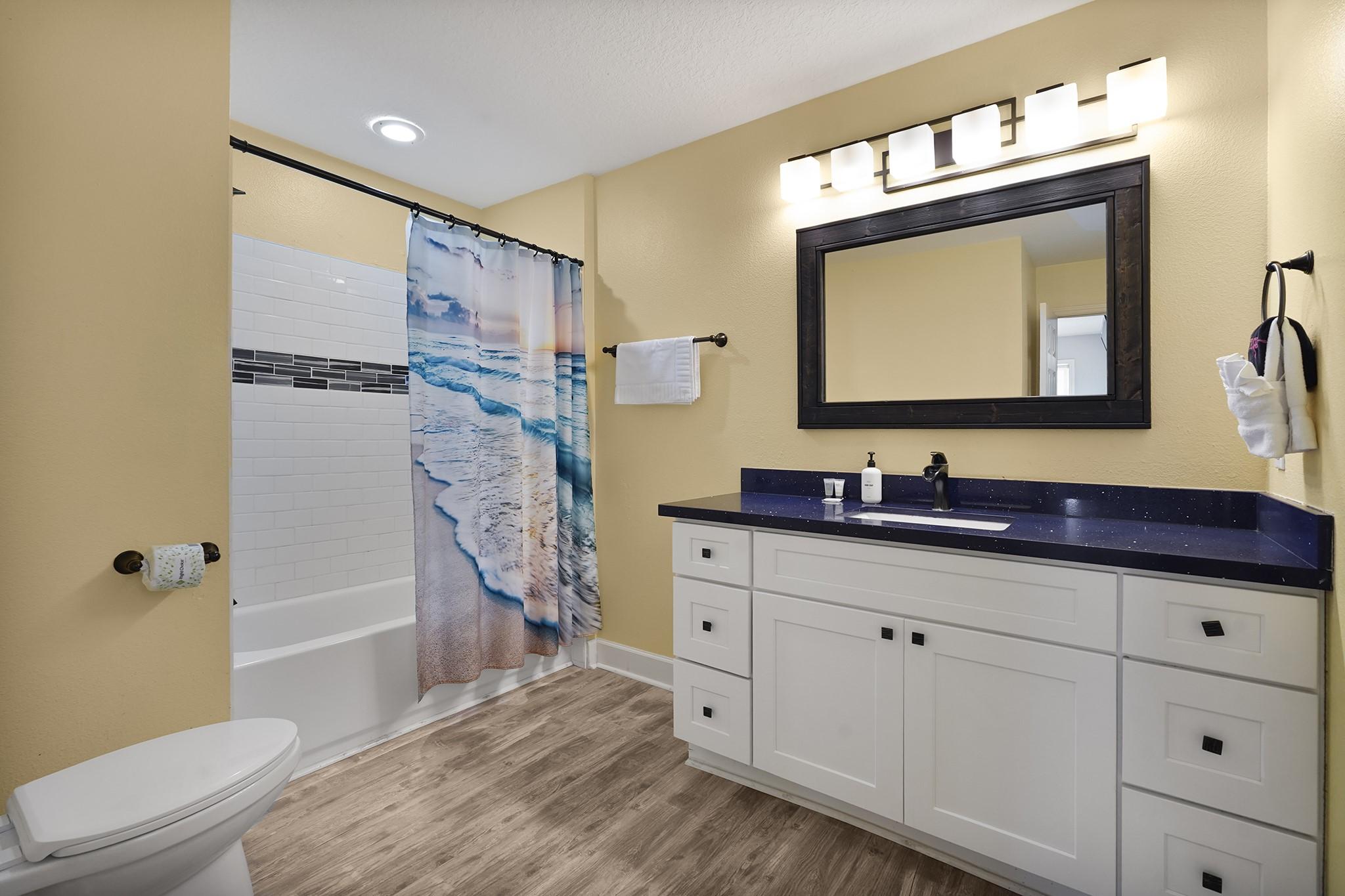 Image 4: Stylish and spacious bathroom featuring an oversiz