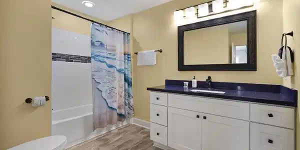 Image 4: Stylish and spacious bathroom featuring an oversiz