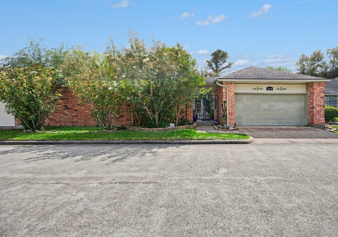 Image 2: Charming curb appeal with lush landscaping and a r