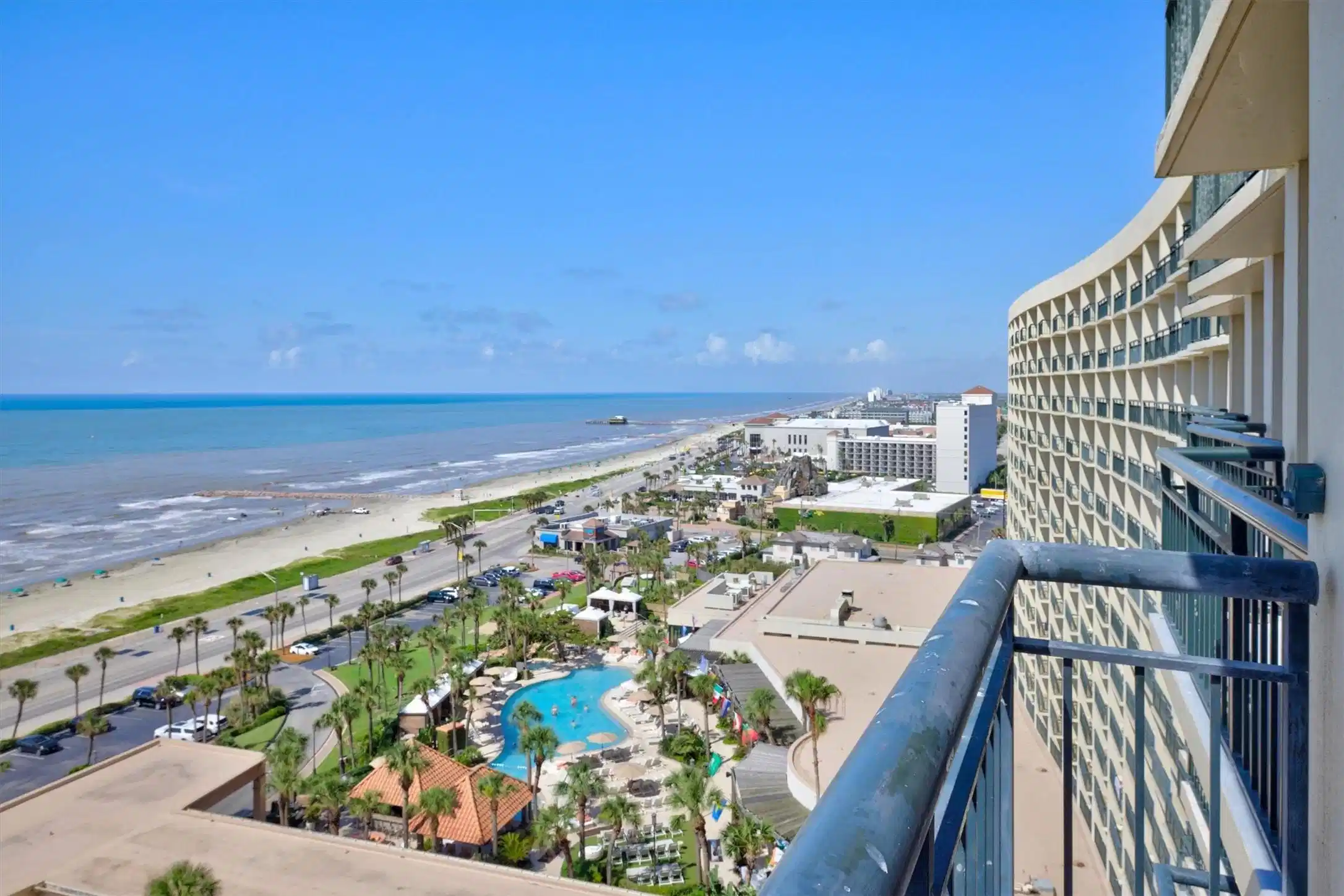 Image 1: Stunning beachside view from a high-rise balcony,