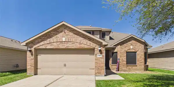 Image 2: Charming brick home with a welcoming facade, featu