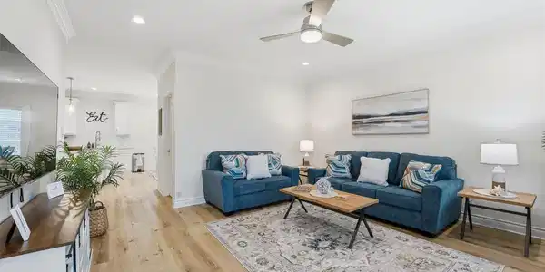 Image 2: Living room flows seamlessly into the kitchen, cre