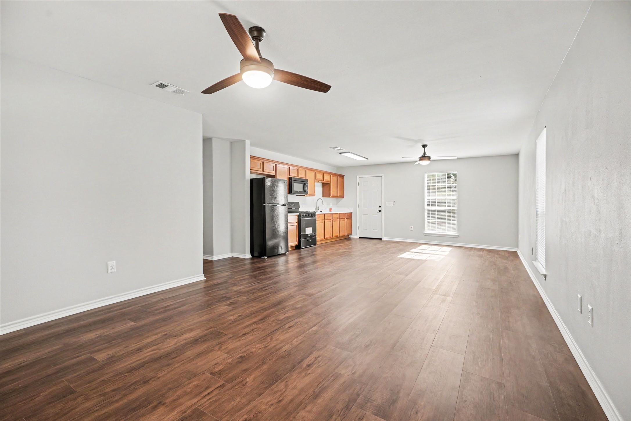 Image 2: This photo showcases a spacious, open-concept livi