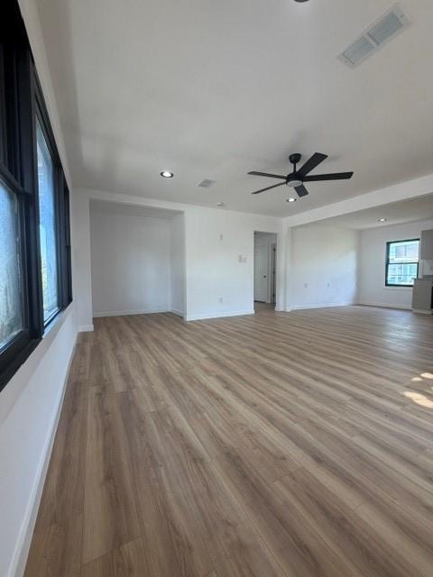 Image 2: This bright, spacious room features sleek wood flo