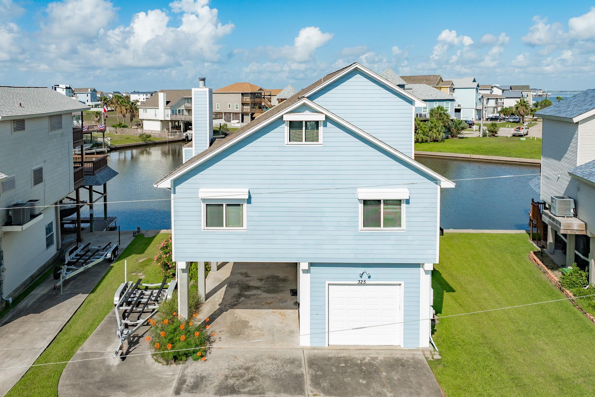 Image 2: Property has a double wide driveway, parking under
