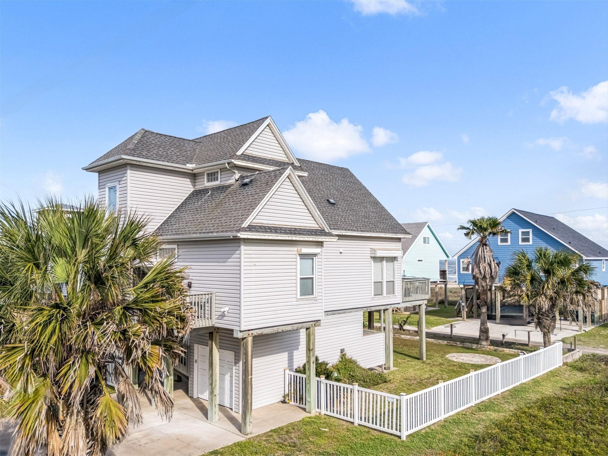 Image 3: The property offers a partially fenced yard, open