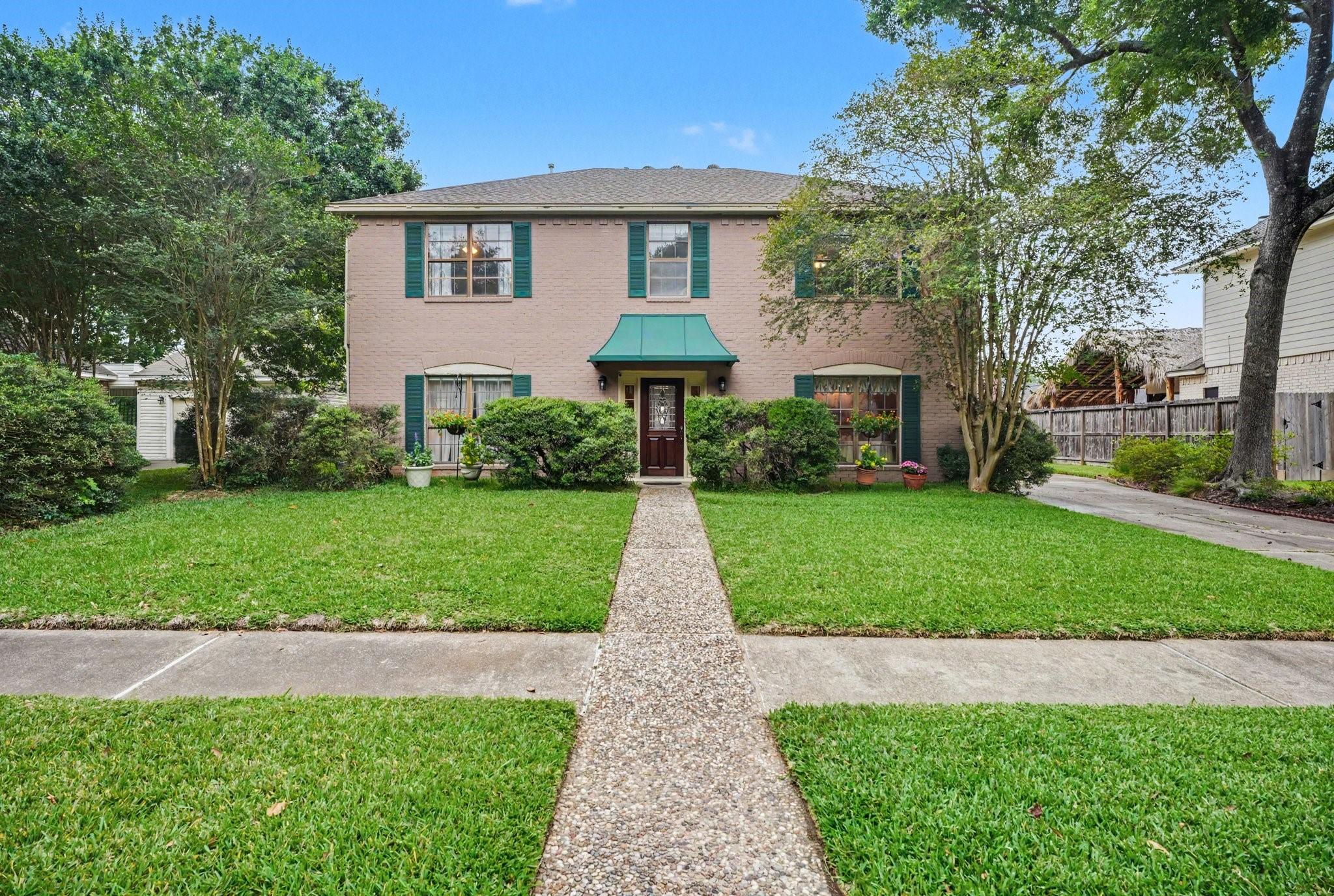 Image 2: Charming two-story home with mature trees, beautif