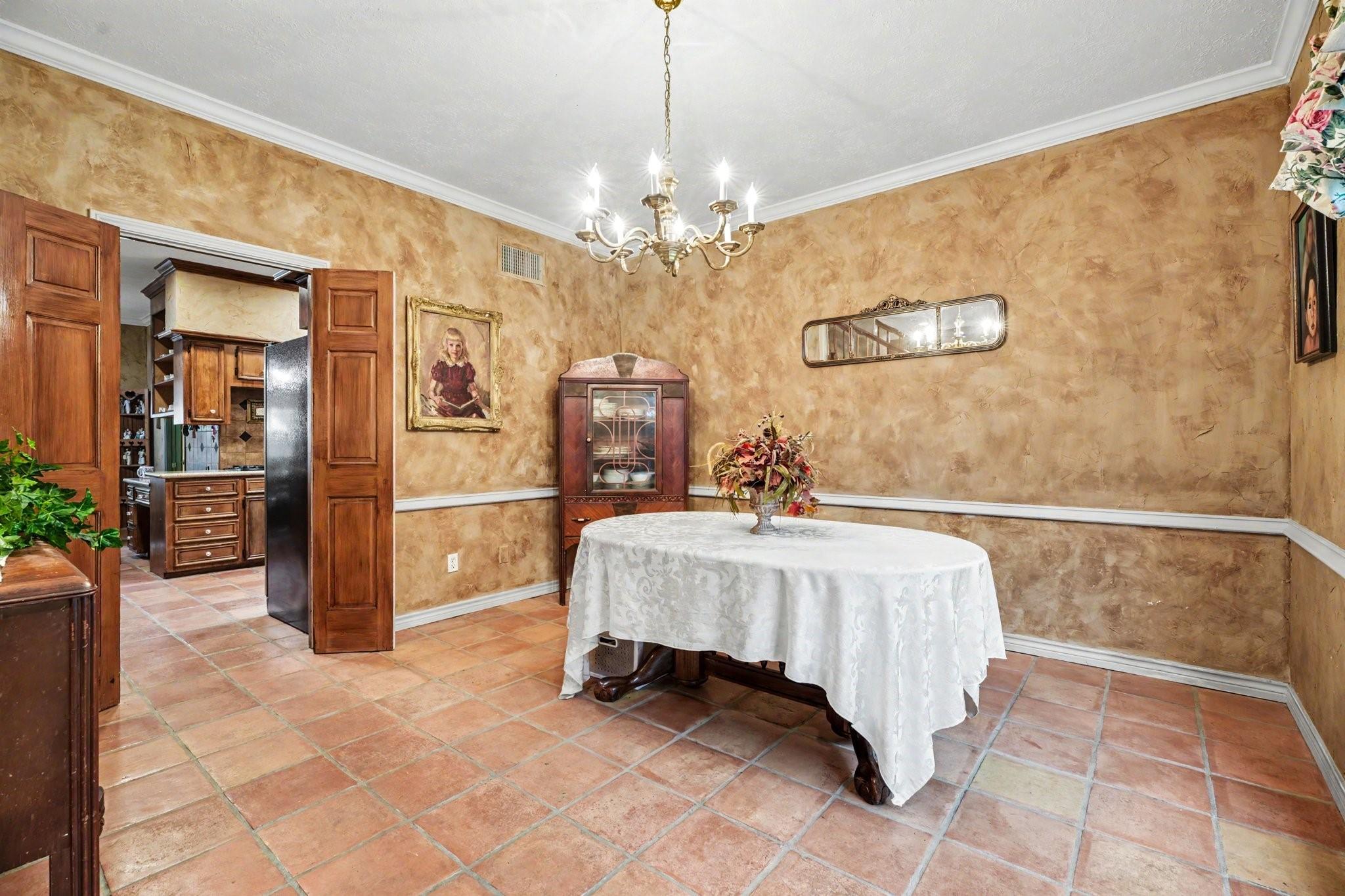 Image 4: Formal dining room with elegant lighting, rich wal