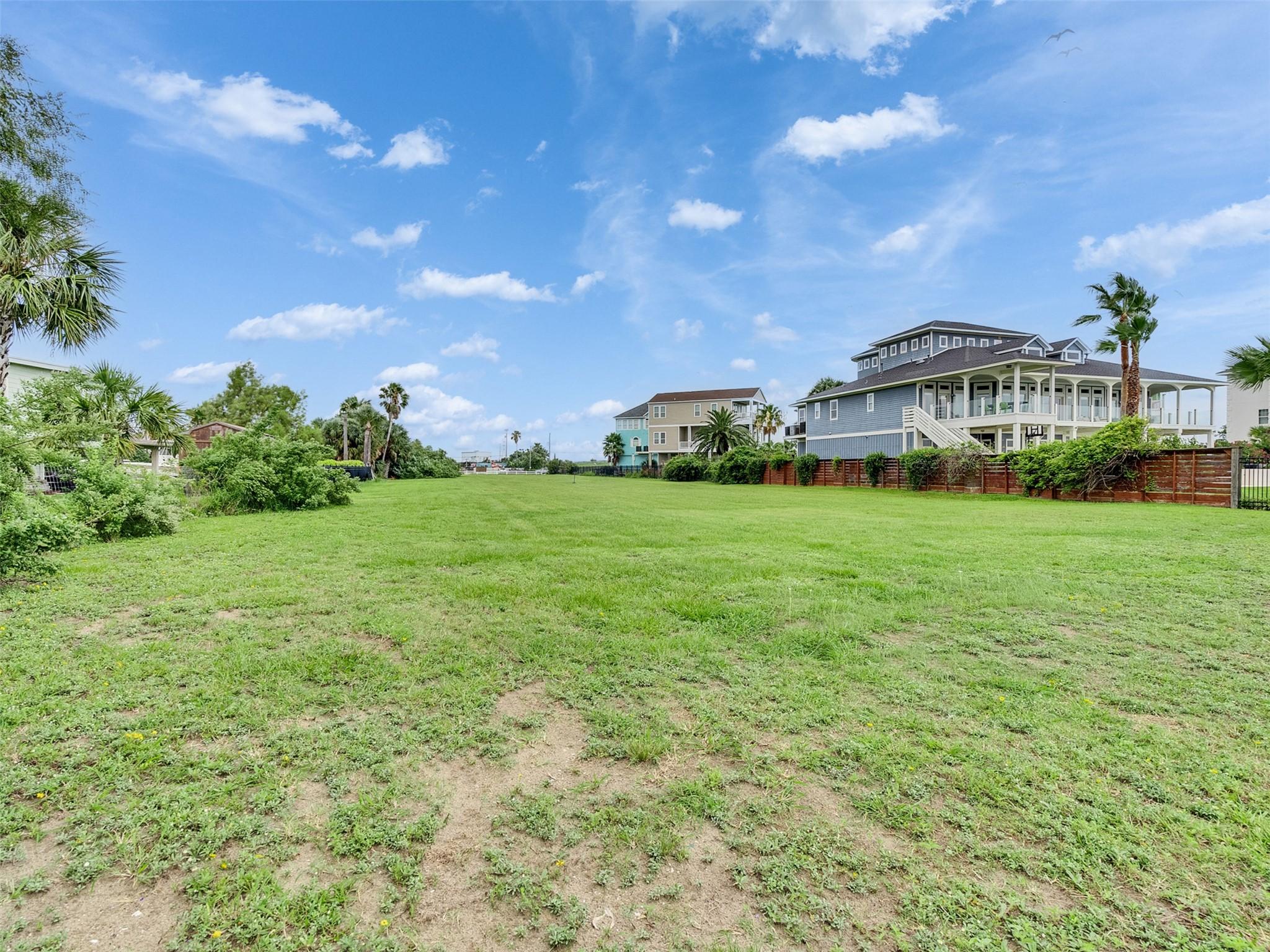 Image 3: Spacious and open grassy lot in a residential area