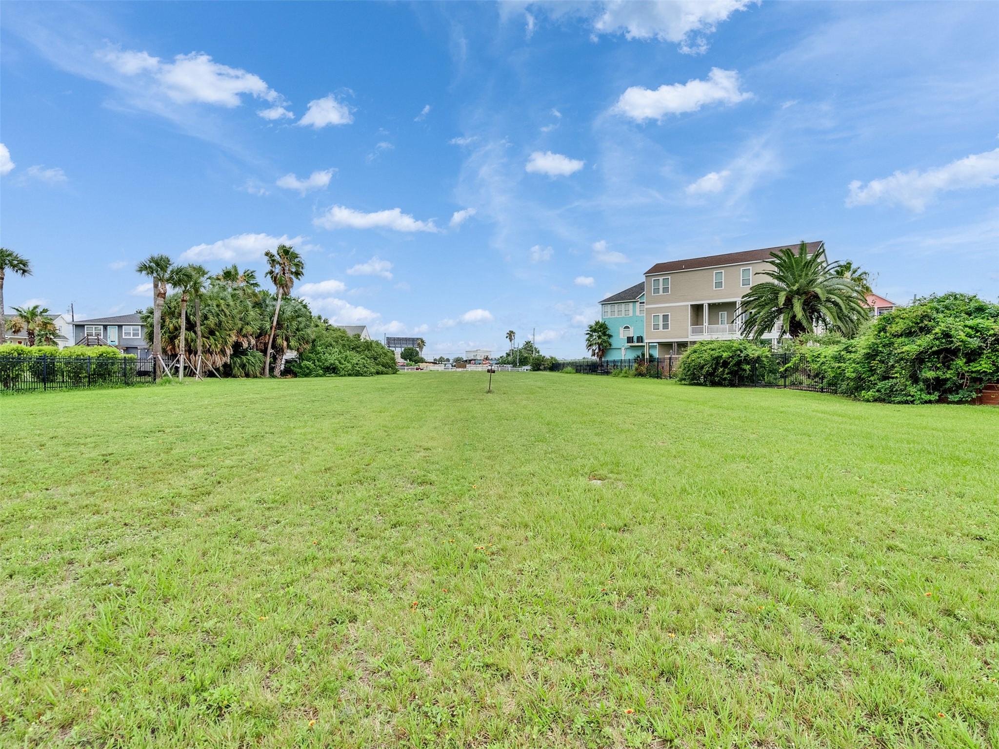 Image 4: Expansive grassy lot in a serene neighborhood, fla
