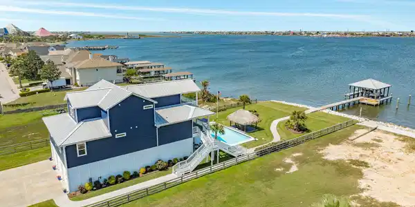 Image 4: Aerial view of the east elevation of the home, sho