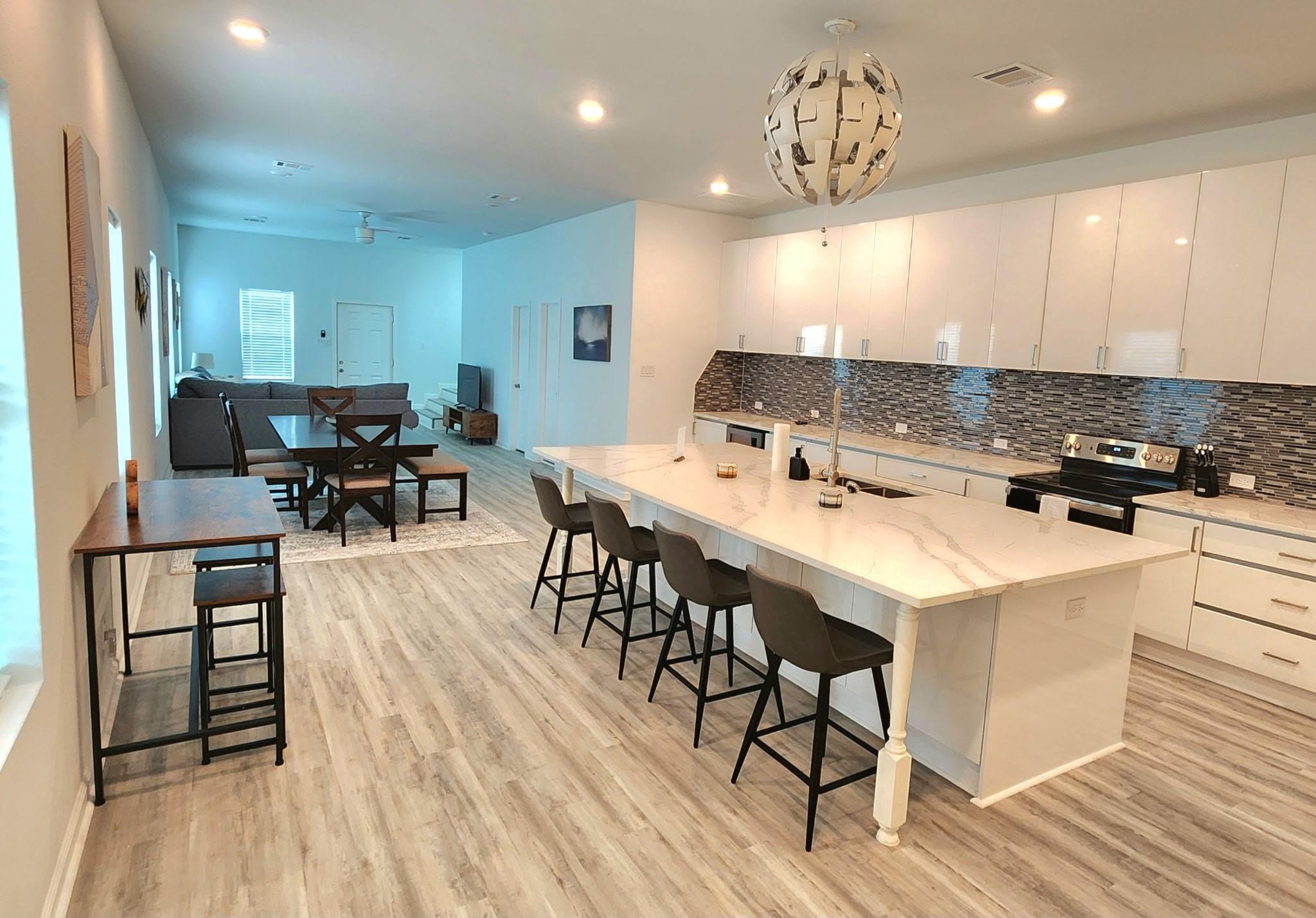 Image 2: This spacious open-concept kitchen and living area