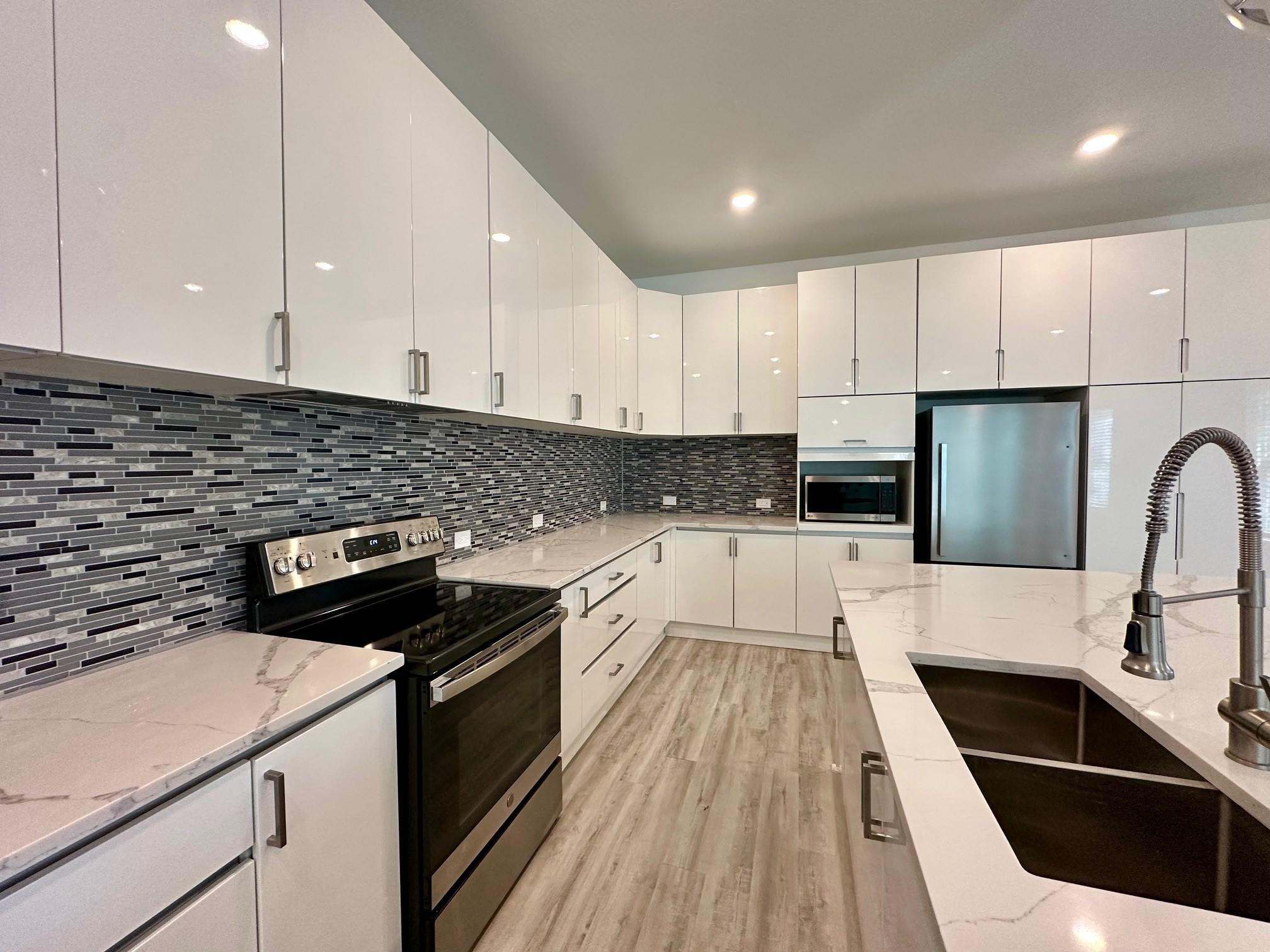 Image 3: Modern kitchen with sleek white cabinetry, stainle