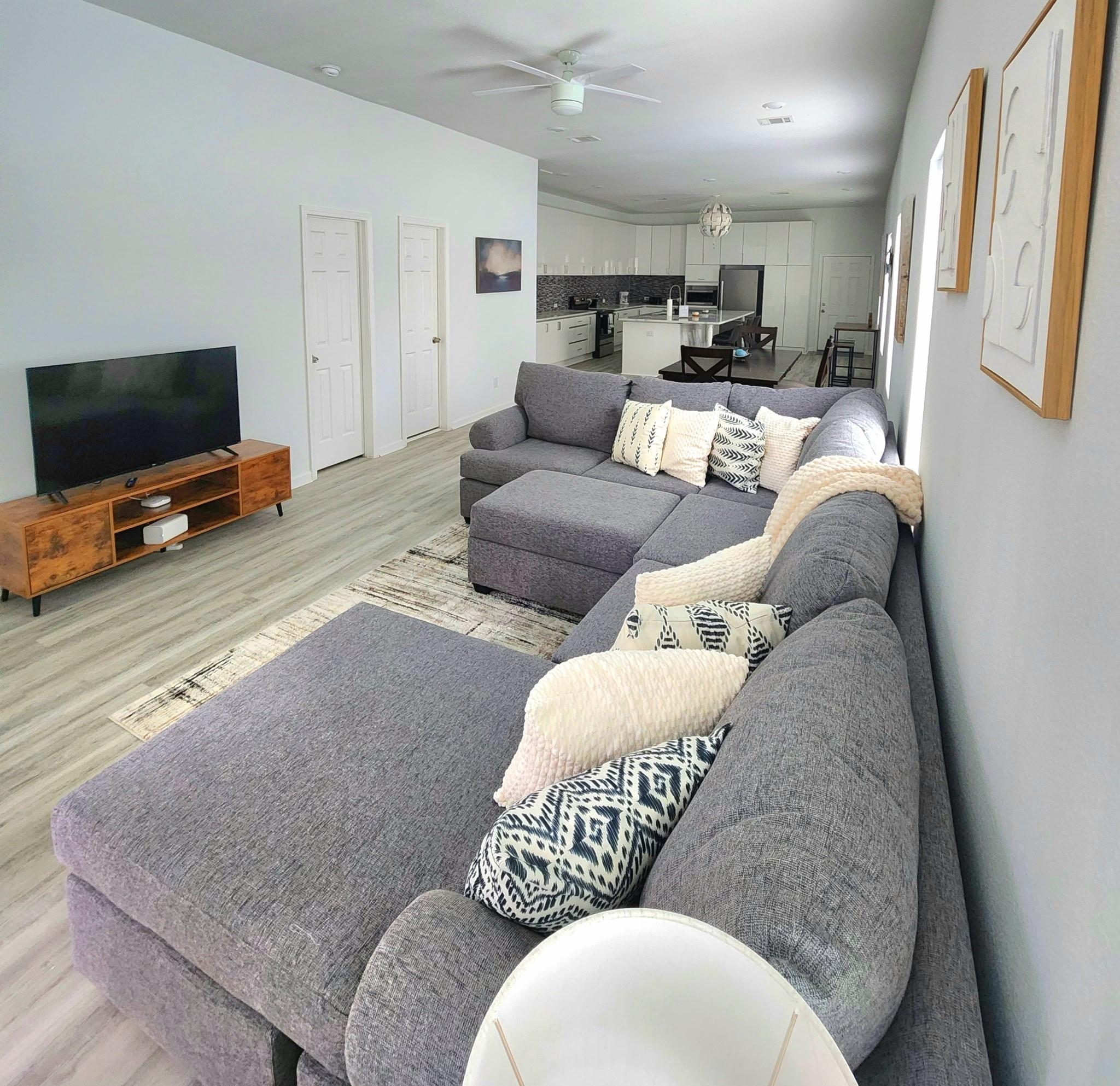 Image 4: Spacious open-concept living area with a modern ki