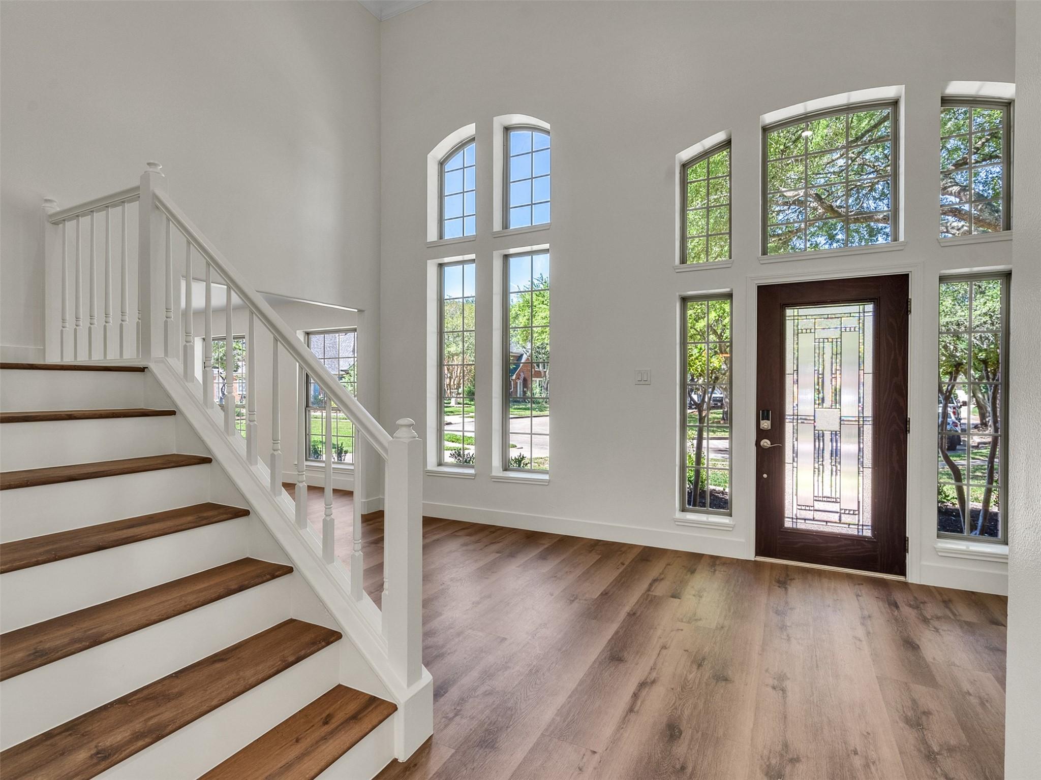 Image 2: Bright, open entryway with high ceilings and large
