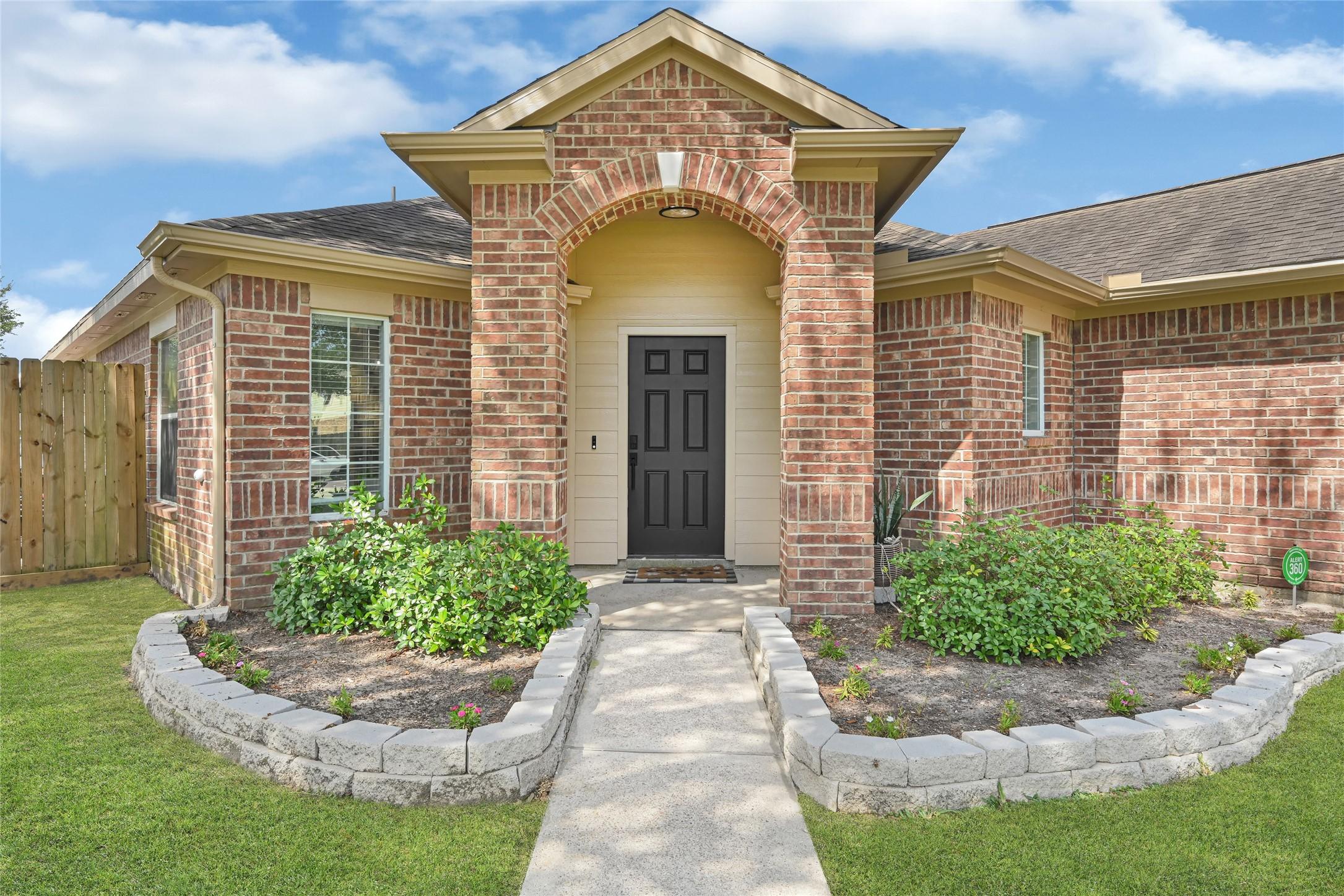Image 3: The corner entry from the beautiful front lawn is