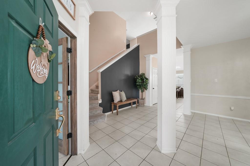 Image 3: Welcoming foyer with soaring ceilings creates an i