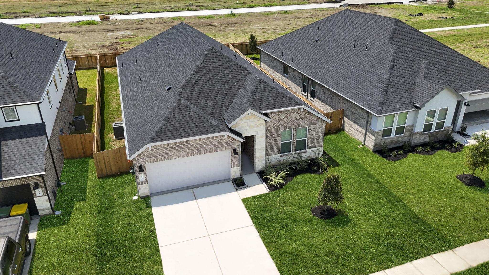 Image 2: An aerial view of the newly built one story home w