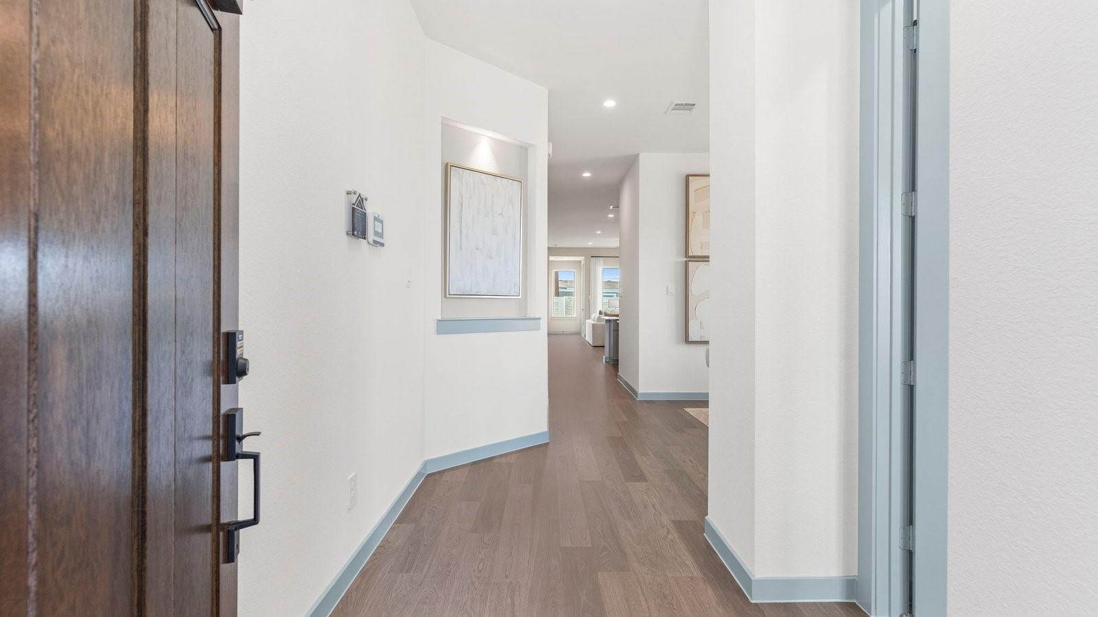 Image 4: Entry way into the home leading to the kitchen in