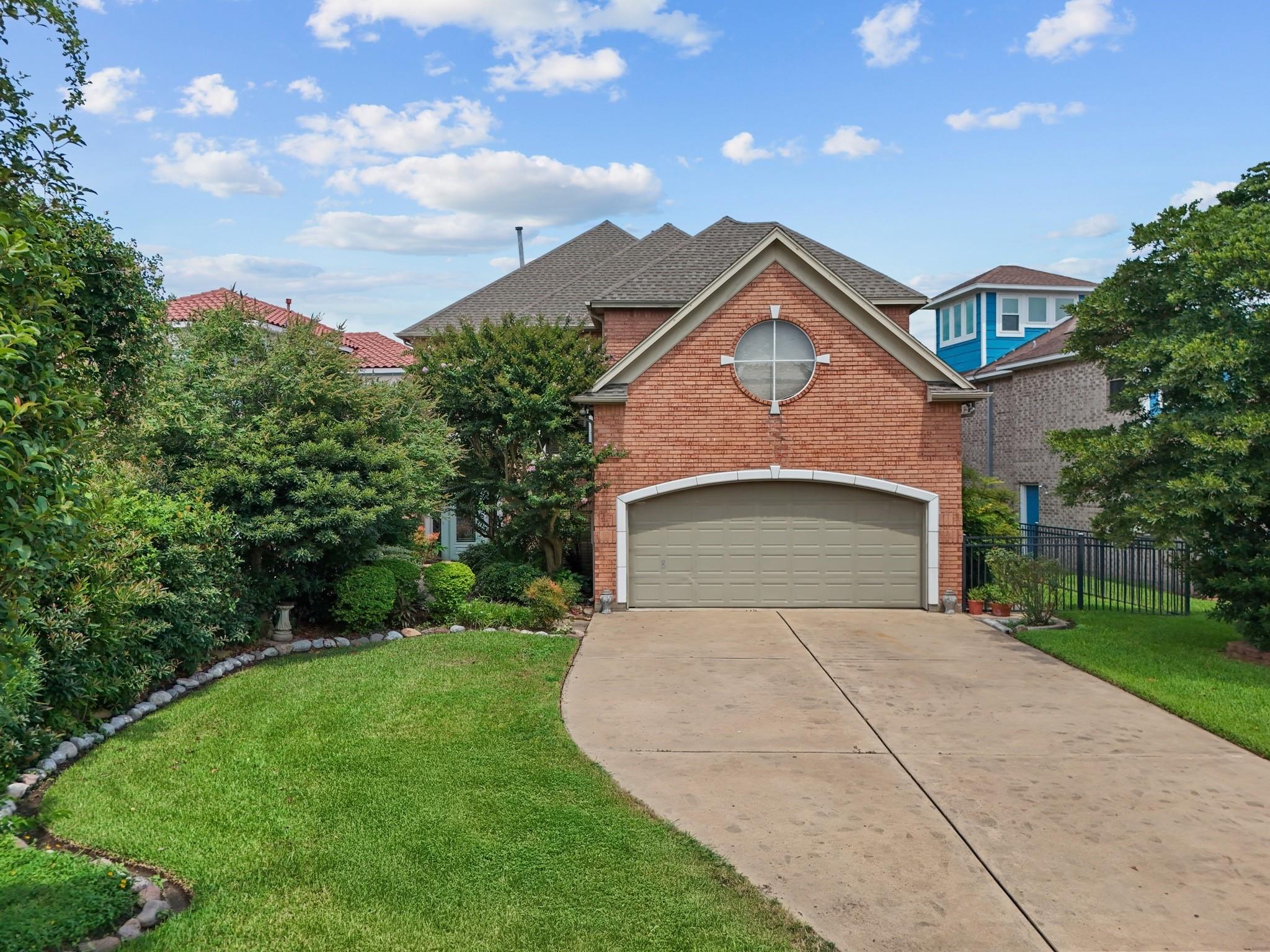 Image 3: Brick exterior with two-car garage and extended dr