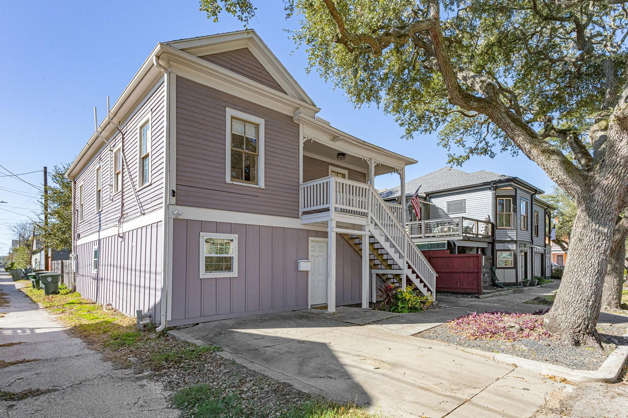 Image 3: This charming two-story home features a classic de