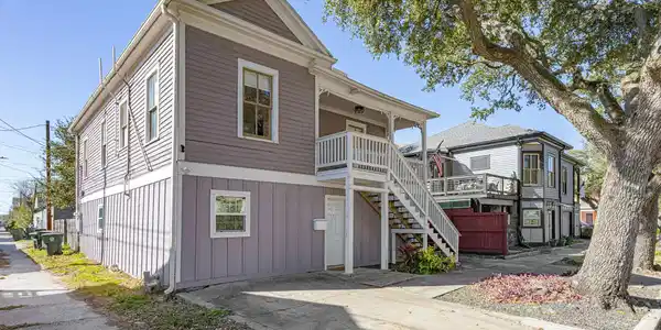 Image 3: This charming two-story home features a classic de