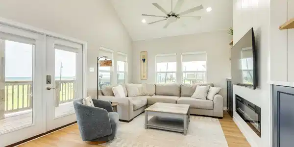 Image 2: Bright, open-concept living room features soaring