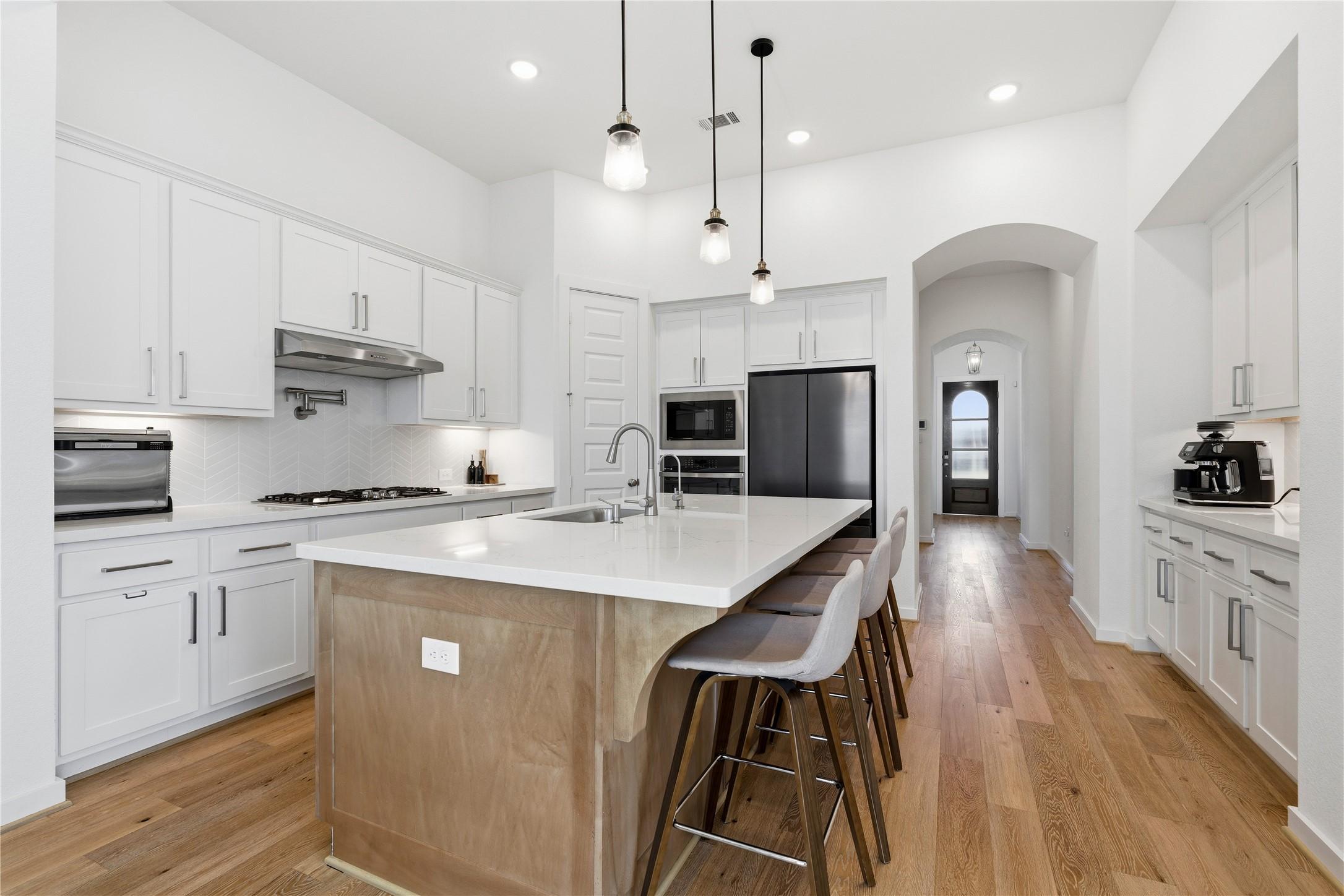 Image 4: Kitchen with gas range, pot filler, stainless appl